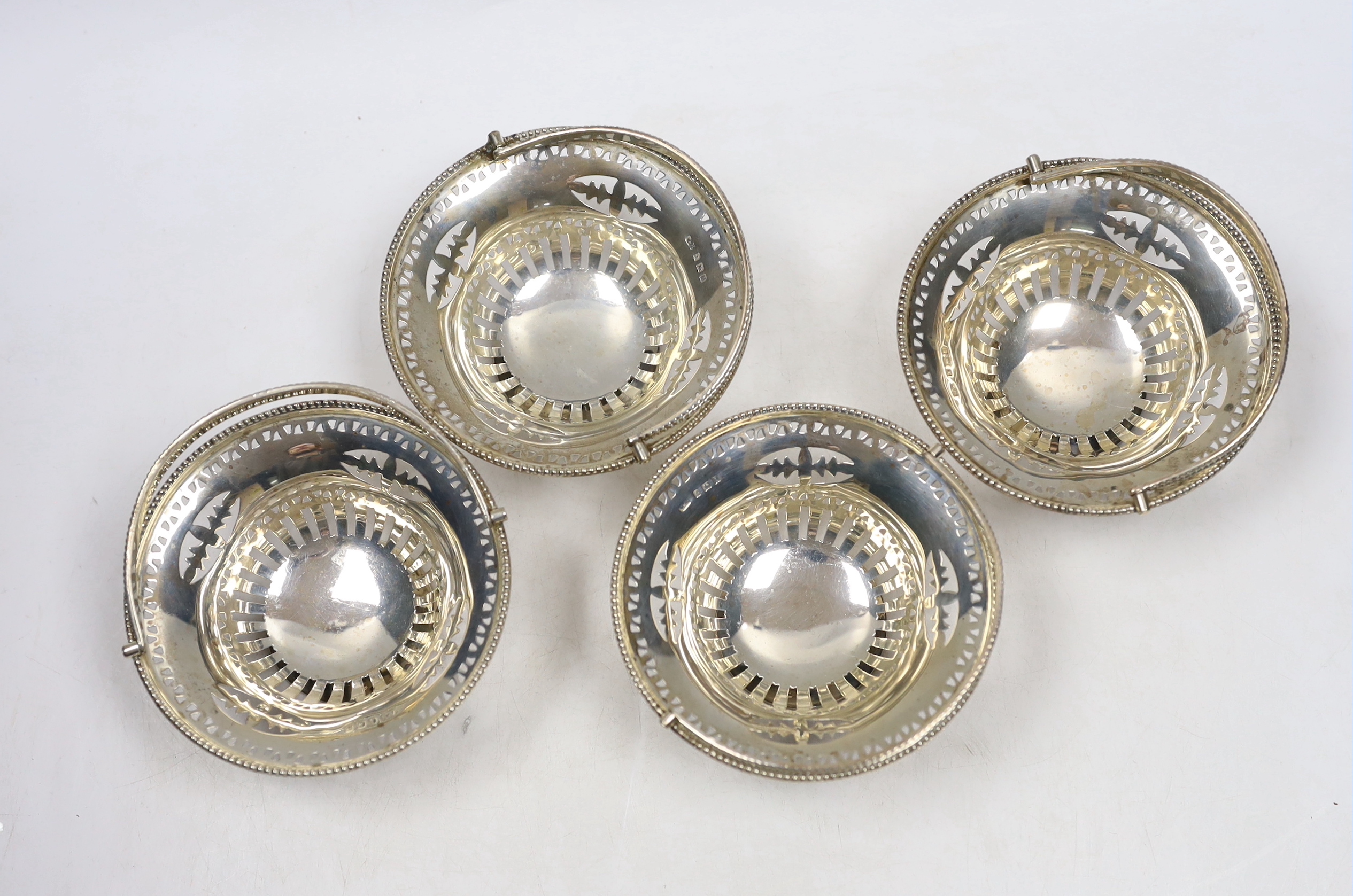 A set of four Edwardian pierced silver circular bonbon baskets, William Neale, Birmingham, 1908, 10cm.